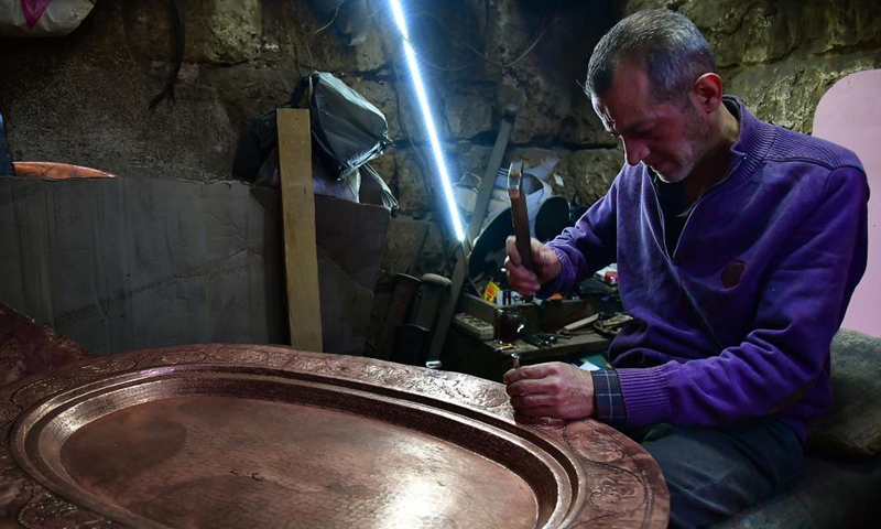A craftsman makes copperware at a workshop in Damascus, Syria, on Nov. 28, 2021.Photo:Xinhua