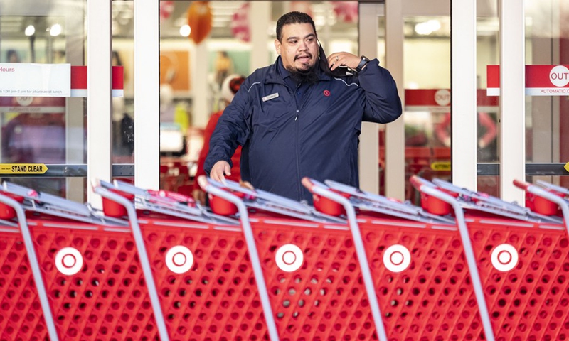 A Target employee opens the doors in Rosemont of Greater Chicago Area, Illinois, the United States, on Nov. 26, 2021.Photo:Xinhua