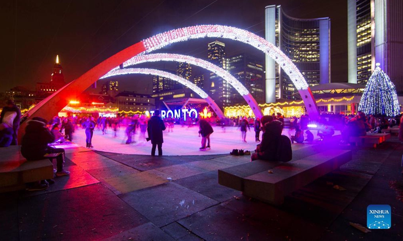 People skate under a light installation during the 2021 Cavalcade of Lights in Toronto, Canada, Nov. 27, 2021.Photo:Xinhua