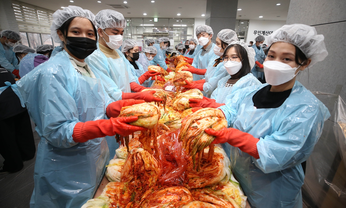 Students from Yeungnam University branch make kimchi in Gyeongsan, South Korea on November 30, 2021. They will give the kimchi to local widows and families in difficulties for free. Photo: VCG