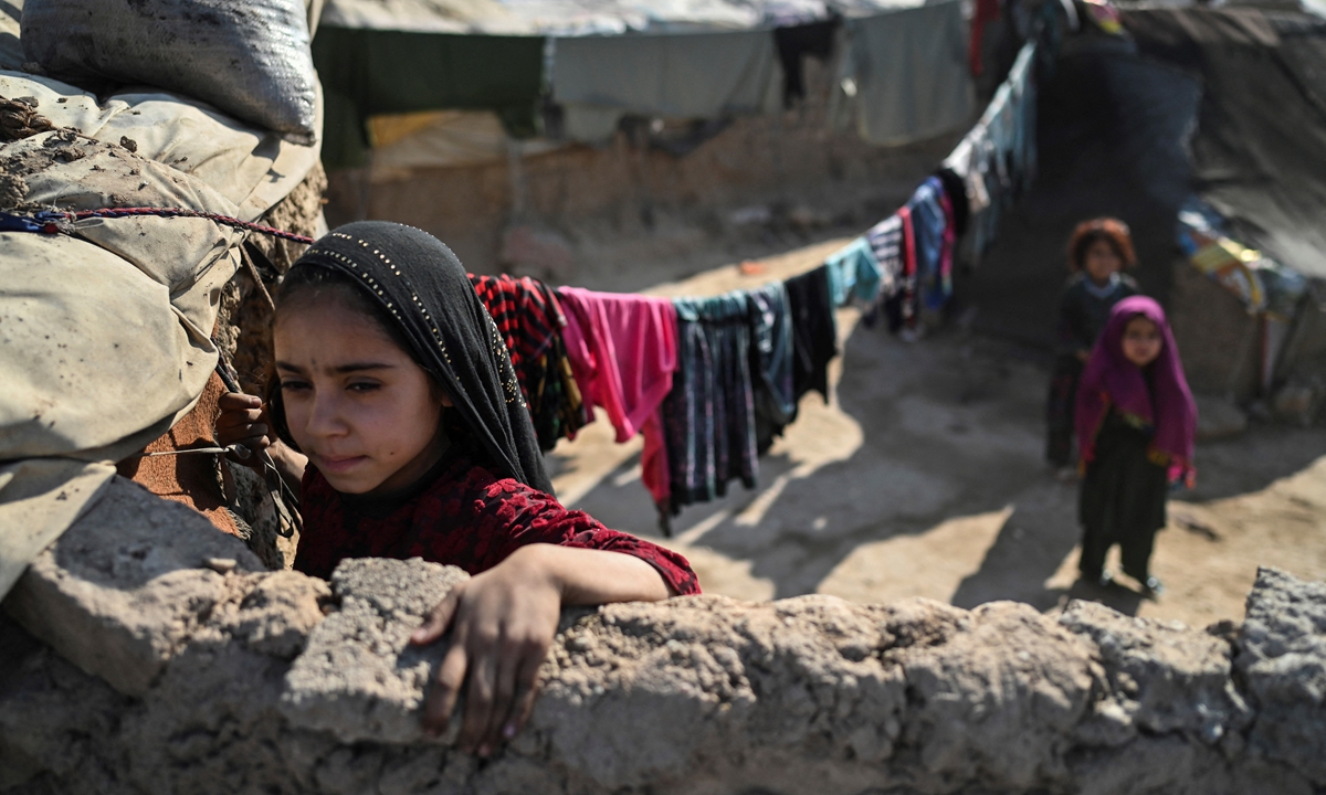 A child stand in an internally displaced person's camp on the outskirts of Herat, Afghanistan on November 22. Photo: AFP