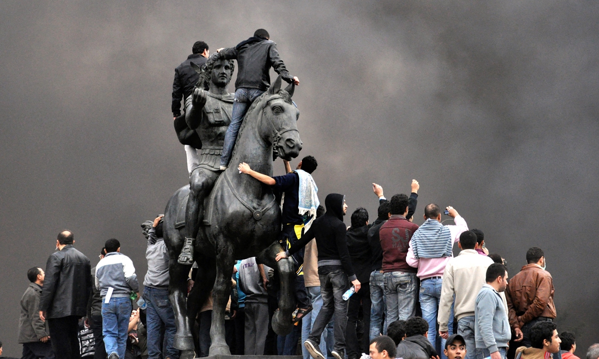 Egyptian protesters gather on the statue of Alexander the Great in Alexandria on January 28, 2011. Photo: AFP