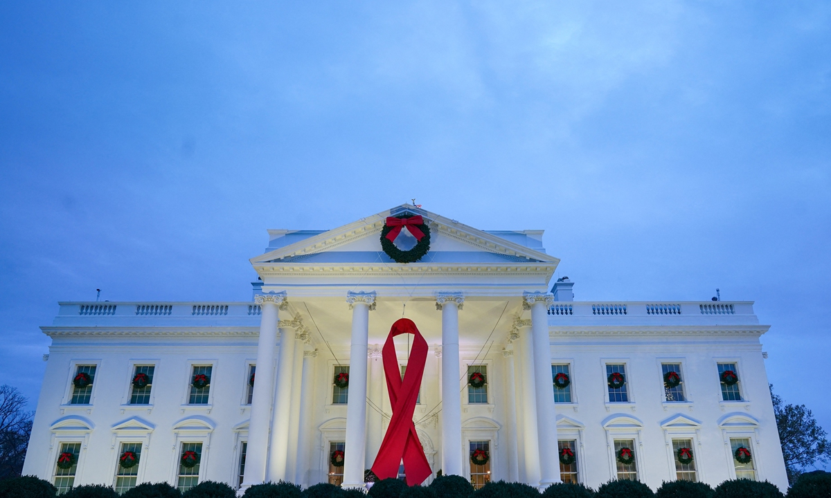 A large red ribbon is seen on the White House to mark World AIDS Day in Washington DC on December 1, 2021. Photo: AFP