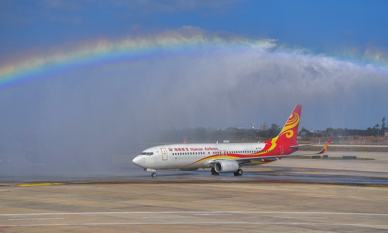 A Hainan Airlines flight gets a watery welcome in Haikou, South China's Hainan Province on December 2, 2021. The second phase expansion project of Haikou Meilan International Airport was put into operation on the same day, welcoming the first batch of passengers. Photo: cnsphoto