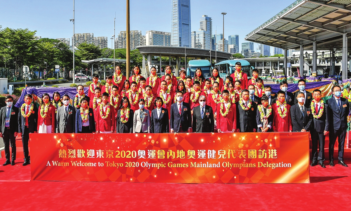 The all-star Olympic delegation of 29 Team China athletes arrives in Hong Kong and takes a group photo at the welcome ceremony on December 3, 2021. Photo: VCG