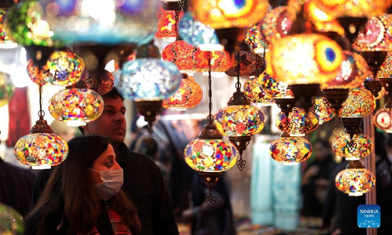 People shop for decorative lights from Turkey during the Punjab International Trade Expo (PITEX) in Amritsar, India's northern state Punjab, on Dec 2, 2021. International traders participate in the PITEX 2021 here from Dec 2 to Dec 6.Photo:Xinhua