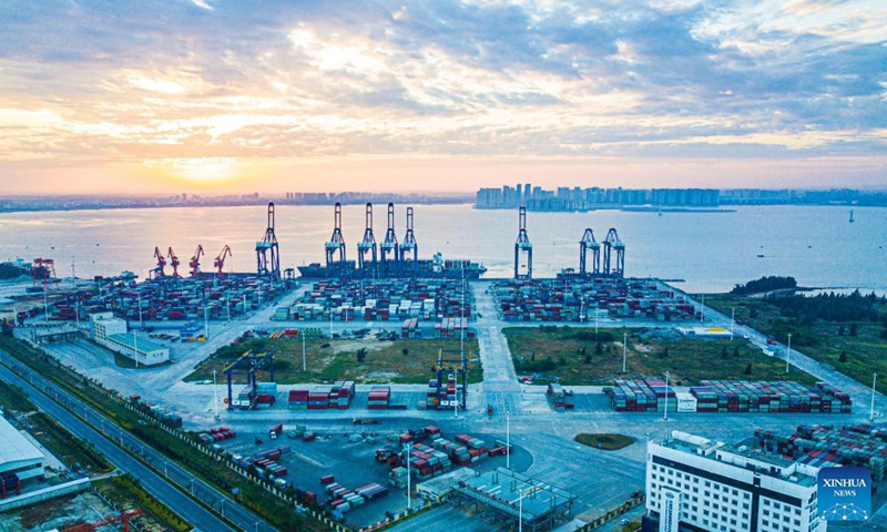 Aerial photo taken on Dec. 5, 2021 shows the sunrise scenery of the Yangpu international container port at Yangpu economic development zone in south China's Hainan Province.Photo:Xinhua