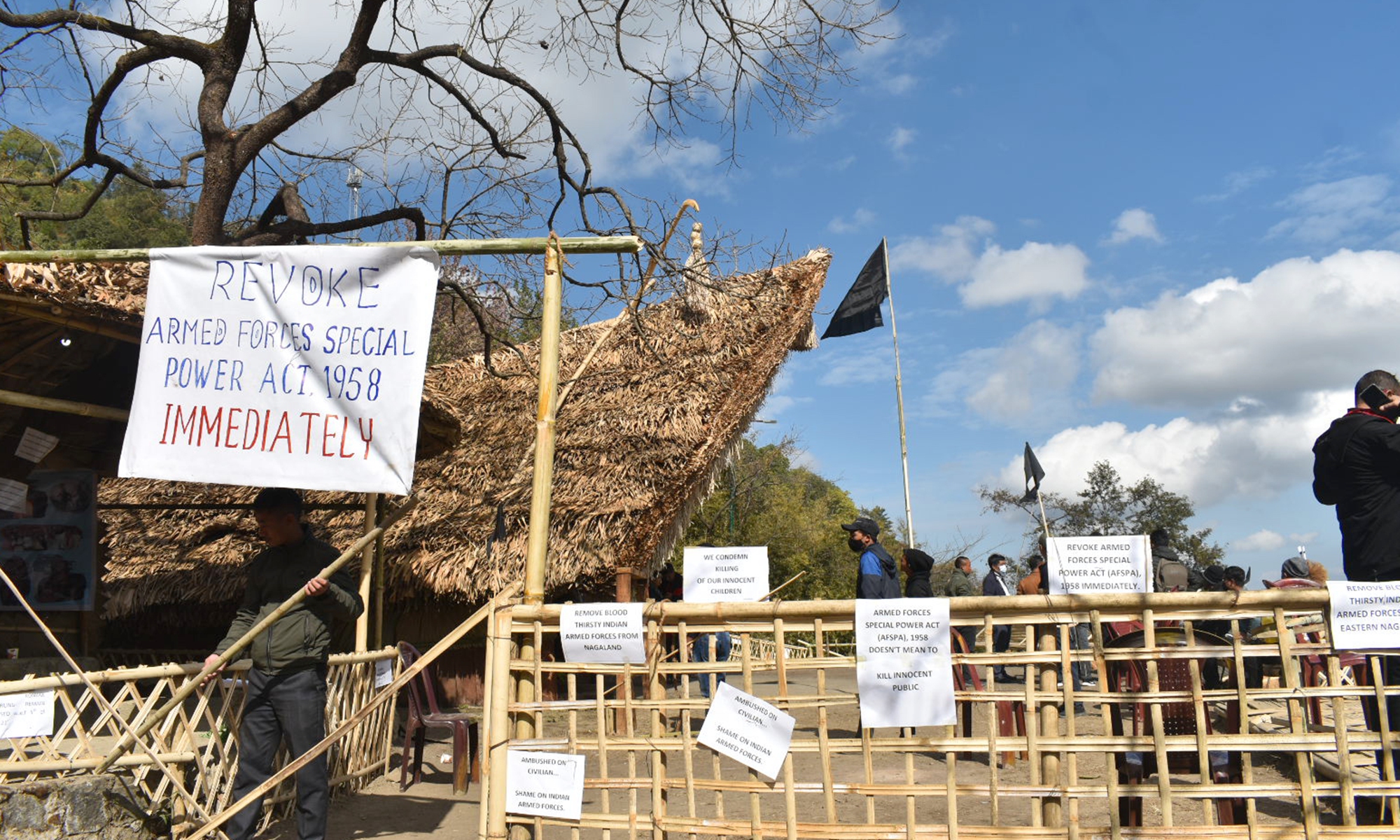 Placards and a black flag are hoisted at the venue of the Hornbill festival on December 5, 2021, in solidarity after the alleged killing of 13 civilians in a case of mistaken identity by Indian security personnel the previous evening in an anti-insurgency operation at Oting village of the Indian northeastern state of Nagaland. Photo: VCG