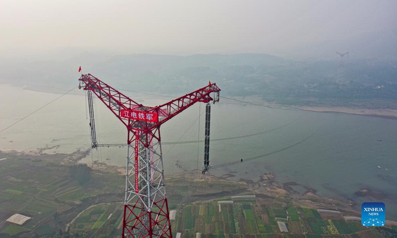 Photo taken on Dec. 5, 2021 shows a utility technician working at the construction site of the Chongqing section of the Baihetan-Jiangsu ultra-high-voltage (UHV) power transmission project over the Yangtze River in southwest China's Chongqing Municipality.Photo:Xinhua