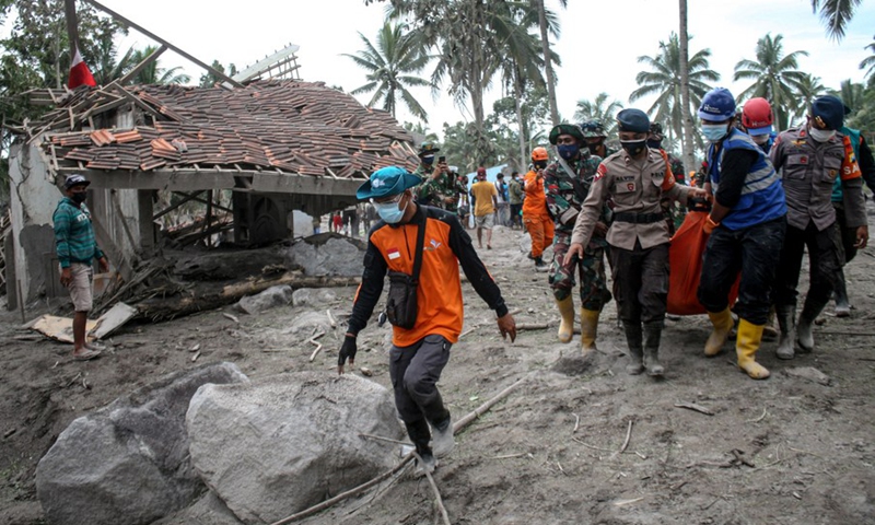 Search And Rescue (SAR) teams bring body packs of victims during a search operation after Mount Semeru erupted near Sumber Wuluh village in Lumajang, East Java, Indonesia, Dec. 6, 2021.(Photo: Xinhua)