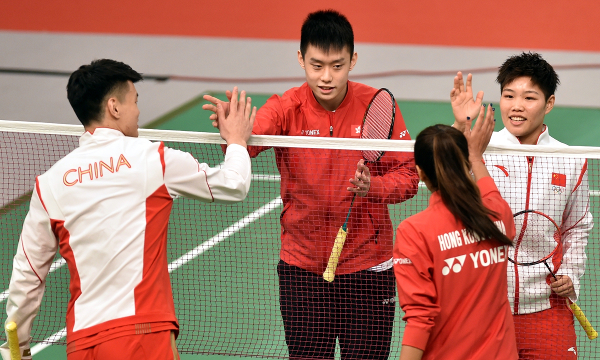 Badminton Olympic champions of Team China Wang Yilü and Huang Dongping play an exhibition match with Hong Kong, China badminton players at Queen Elizabeth Stadium in Hong Kong on December 4, 2021. Photo: IC
