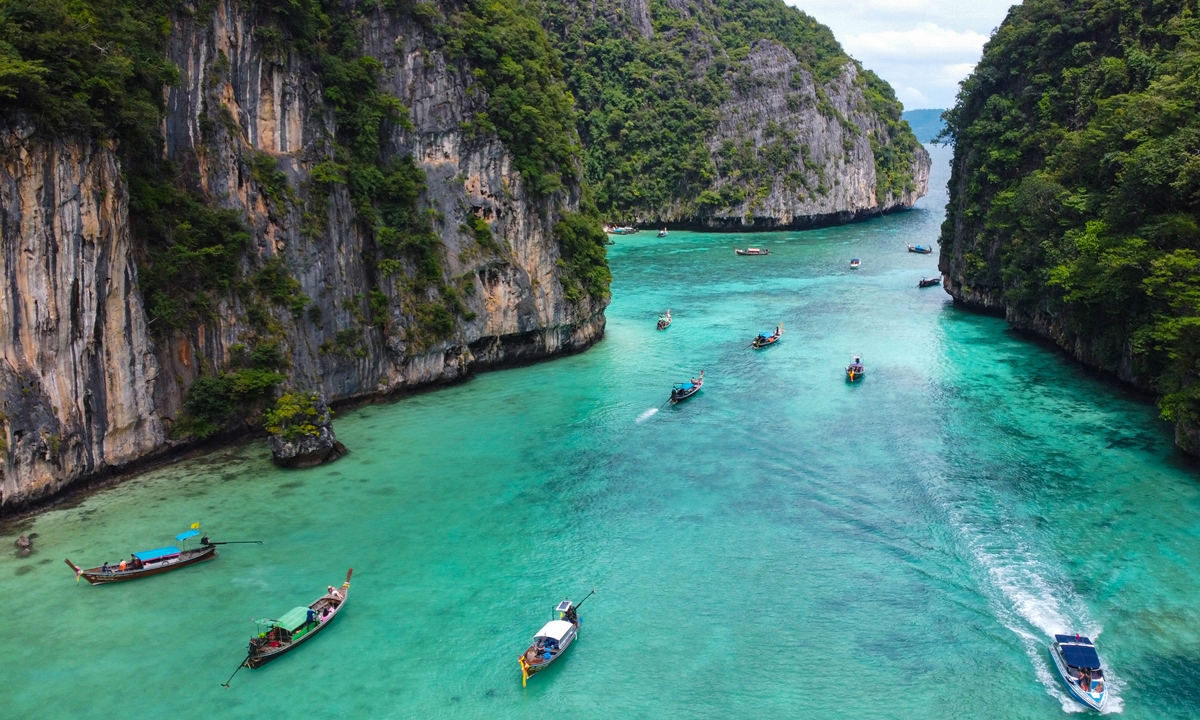 This aerial picture taken on November 26, 2021 shows tourists entering Pi Leh Bay on Thailand's Phi Phi Leh island in longtail boats. Photo: AFP