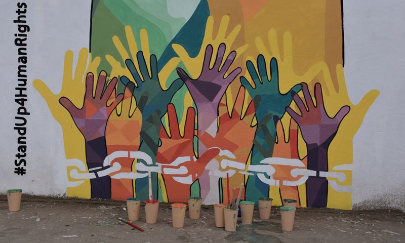 A painting on the wall created by Afghan artists to commemorate the Human Right Days in Mazar-i-Sharif, Balkh Province, Afghanistan, Dec. 10, 2019.(Photo: Xinhua)