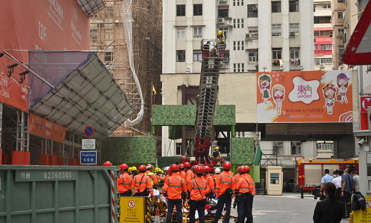 Firemen work to rescue people from the 38-storey World Trade Centre building, which suffered an electrical fire trapping hundreds on the rooftop, in the Causeway Bay district of Hong Kong SAR on December 15, 2021.&nbsp;Photo: AFP