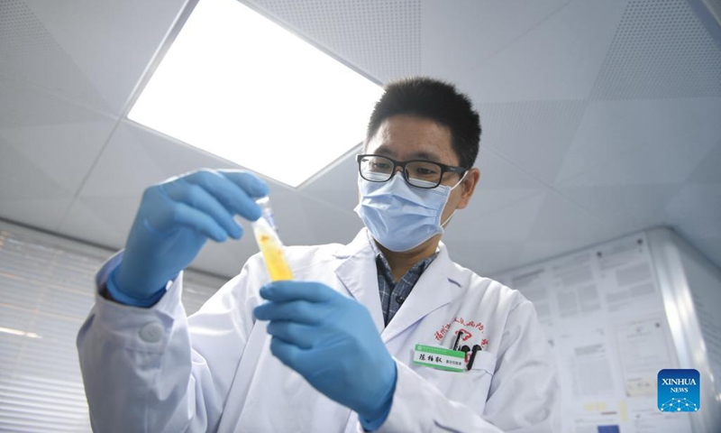 Chen Borui checks the culture of bacteria strains in a laboratory at Fuzhou Dermatosis Prevention Hospital in Fuzhou, southeast China's Fujian Province, Dec. 8, 2021. Having been studying and working on the Chinese mainland for almost two decades, Chen Borui from southeast China's Taiwan said he has witnessed the rapid growth of the mainland and benefited from it. (Photo:Xinhua)