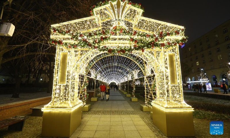 People enjoy light decorations in Warsaw, Poland, Dec. 7, 2021. Every year the Old Town in the city is decorated with thousands of objects in different colors of lights for the Christmas season.Photo:Xinhua