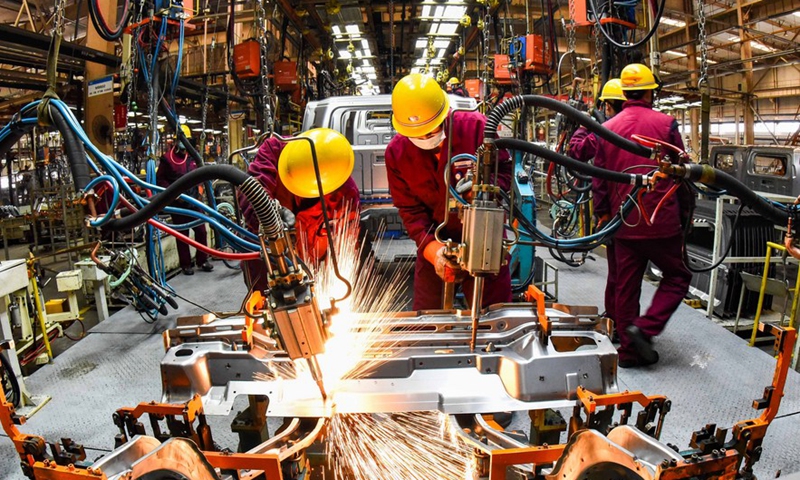Workers weld at a workshop of an automobile manufacturing enterprise in Qingzhou City, east China's Shandong Province, Feb 28, 2021.Photo:Xinhua