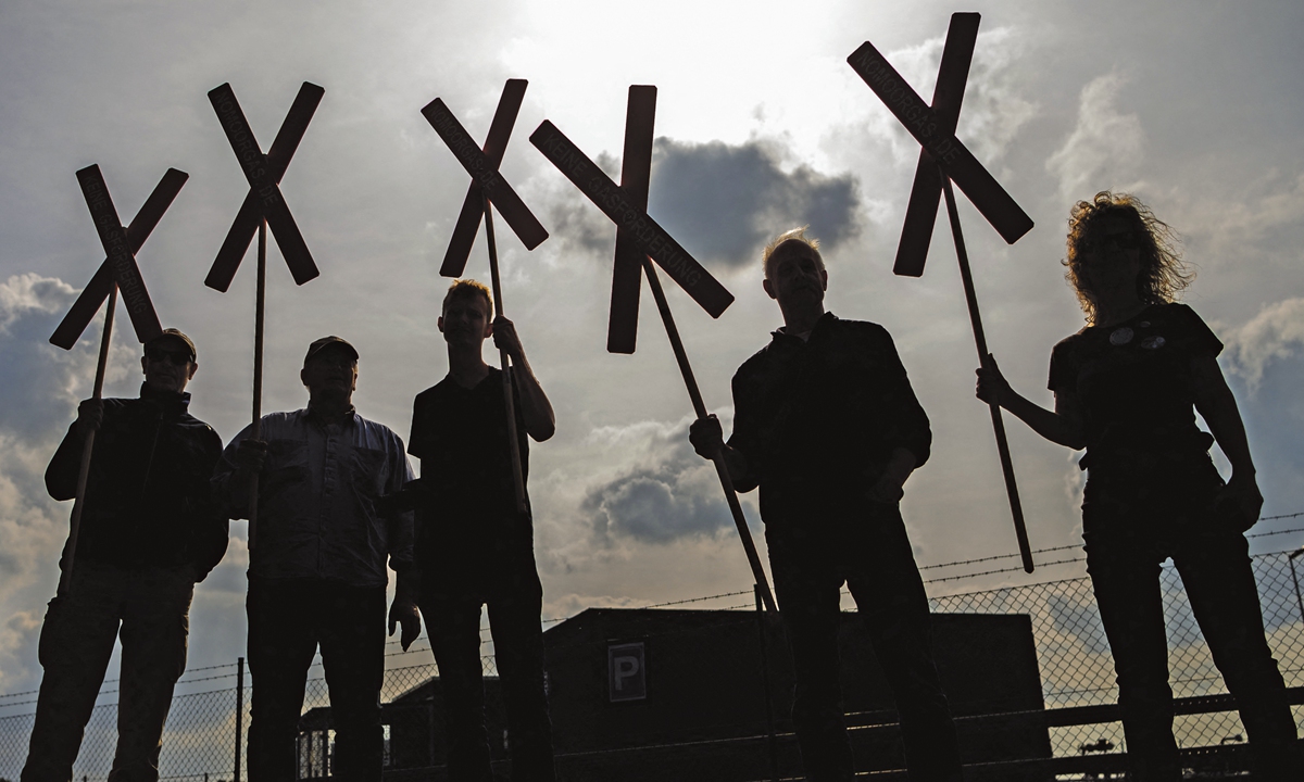 Citizens stand with crosses protesting the oil drilling front of the field. Photo: AFP