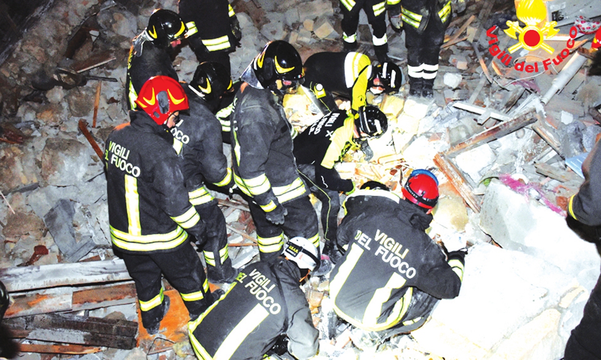 Emergency workers respond after a four-story apartment building collapsed following a gas explosion in Sicily, Italy on December 12, 2021. At least three people were killed and six are missing. Photo: AFP