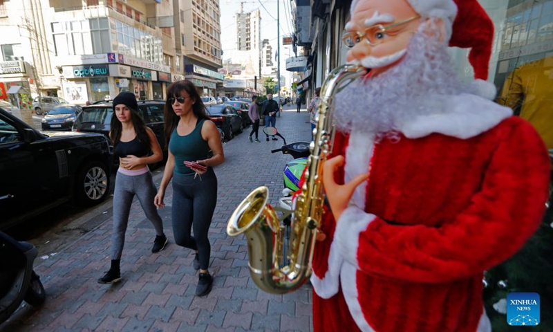 People walk past a store selling Christmas decorations in Beirut, Lebanon, on Dec. 11, 2021.Photo:Xinhua