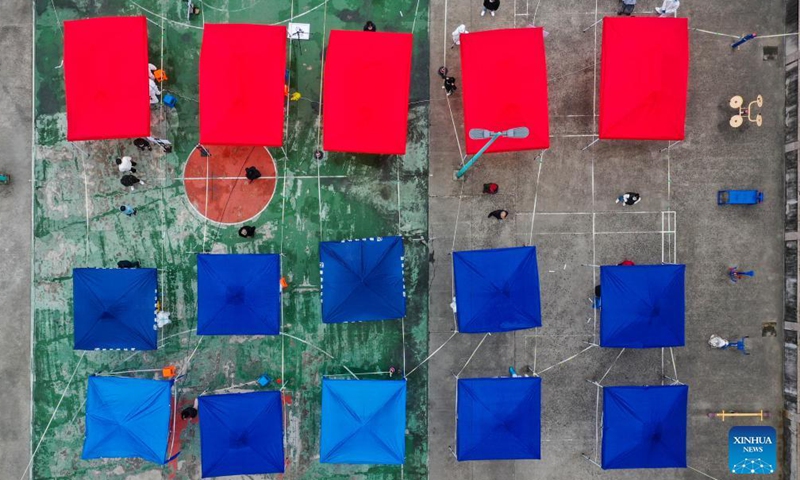 Aerial photo taken on Dec. 12, 2021 shows residents lining up for nucleic acid test at a testing site in Zhenhai District of Ningbo City, east China's Zhejiang Province.Photo:Xinhua