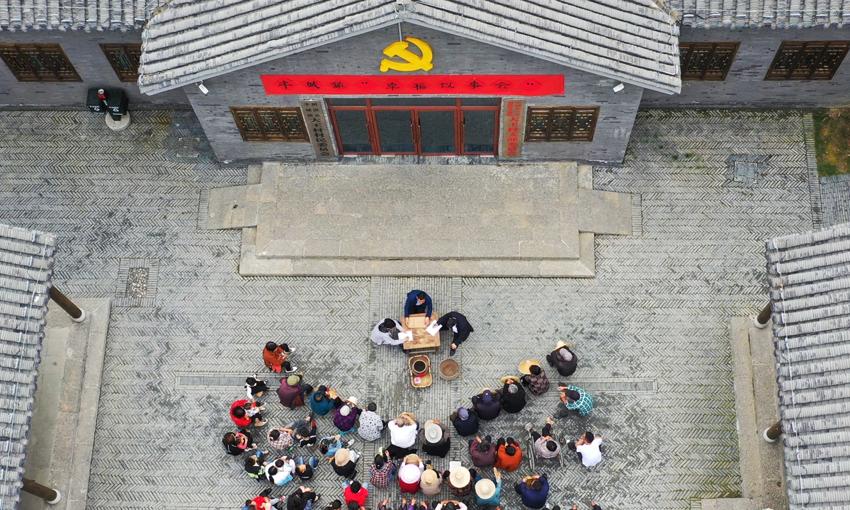 Villagers in Dawang village, Suqian of East China's Jiangsu Province attend the village's 