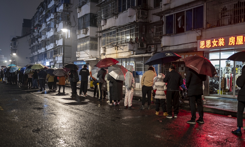 Residents in the city of Shaoxing, East China's Zhejiang Province line up to take nucleic acid testing on December 12, 2021. Photo: VCG