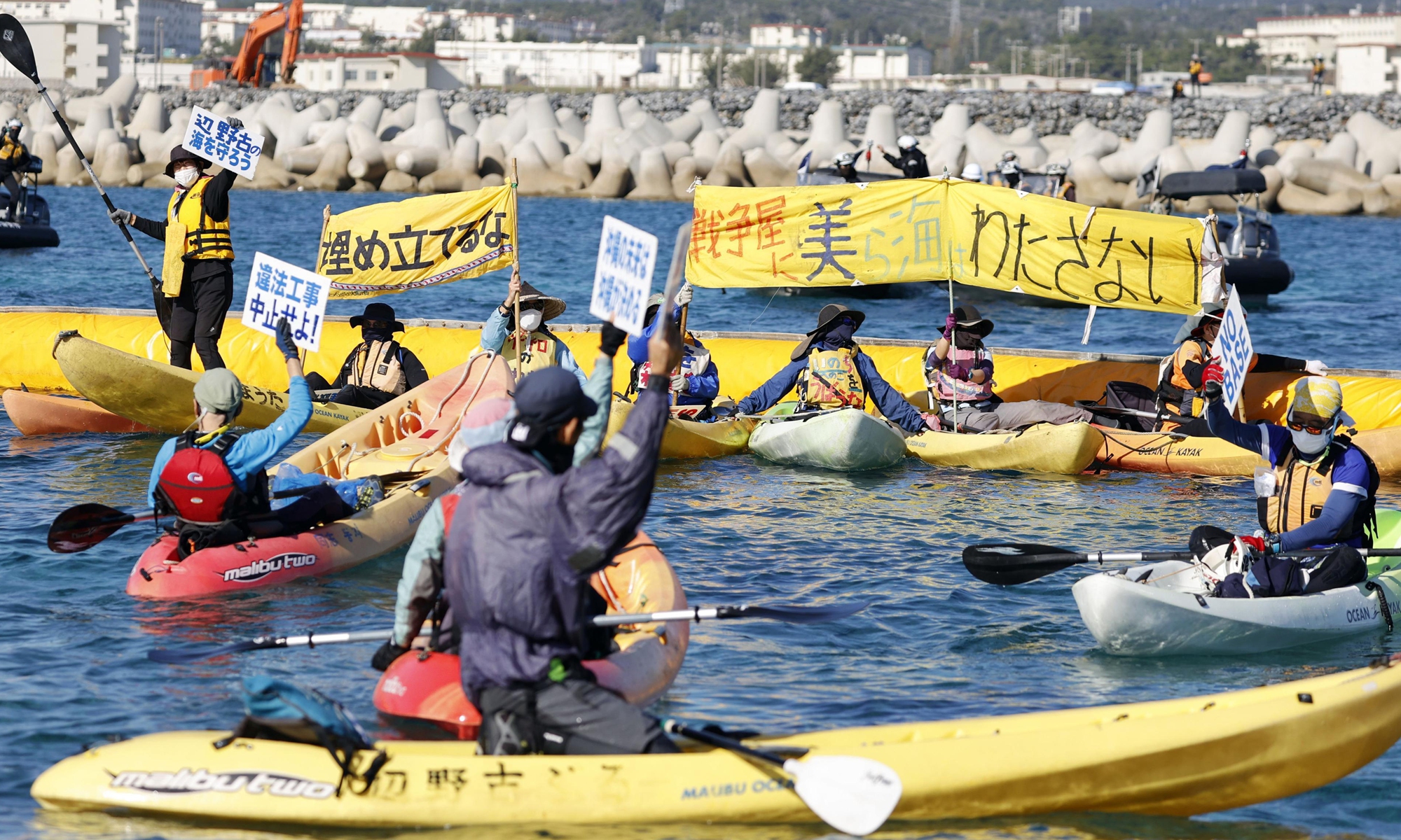 Demonstrators in canoes protest against land reclamation work for the planned relocation of the US Marine Corps Air Station Futenma in the Henoko coastal area of Nago in Okinawa Prefecture, southern Japan, on December 14, 2021. The protest came three years after full-blown offshore landfill work for the transfer began. Photo: IC