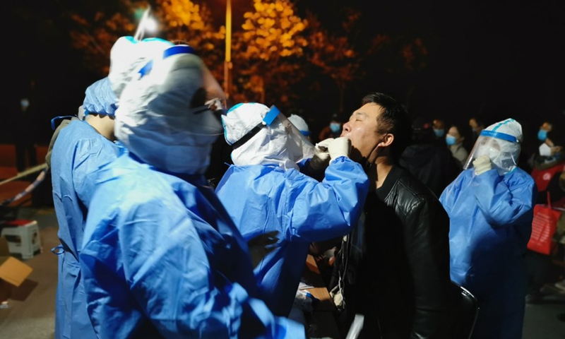 A medical worker takes swab samples from a resident in Hangu Street of Binhai New Area, north China's Tianjin Municipality. File Photo: Xinhua