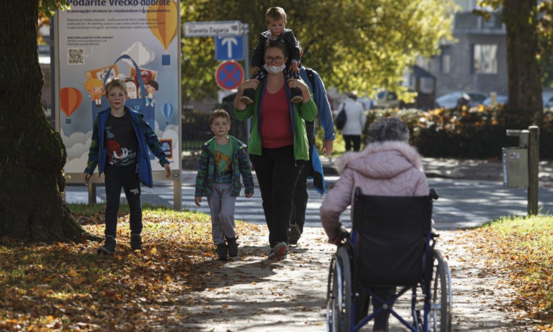 Družina na sprehodu po parku v Kranju, Slovenija, 28. oktober 2020 (Foto: Xinhua)