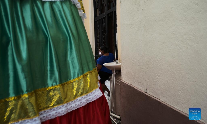 A woman stands outside a building in Leon, Nicaragua, Dec. 15, 2021. Leon, the capital of the Province of Leon, is located along the Chiquito River. Leon is also the second largest city in Nicaragua and is home to the famous Leon Cathedral. (Xinhua)