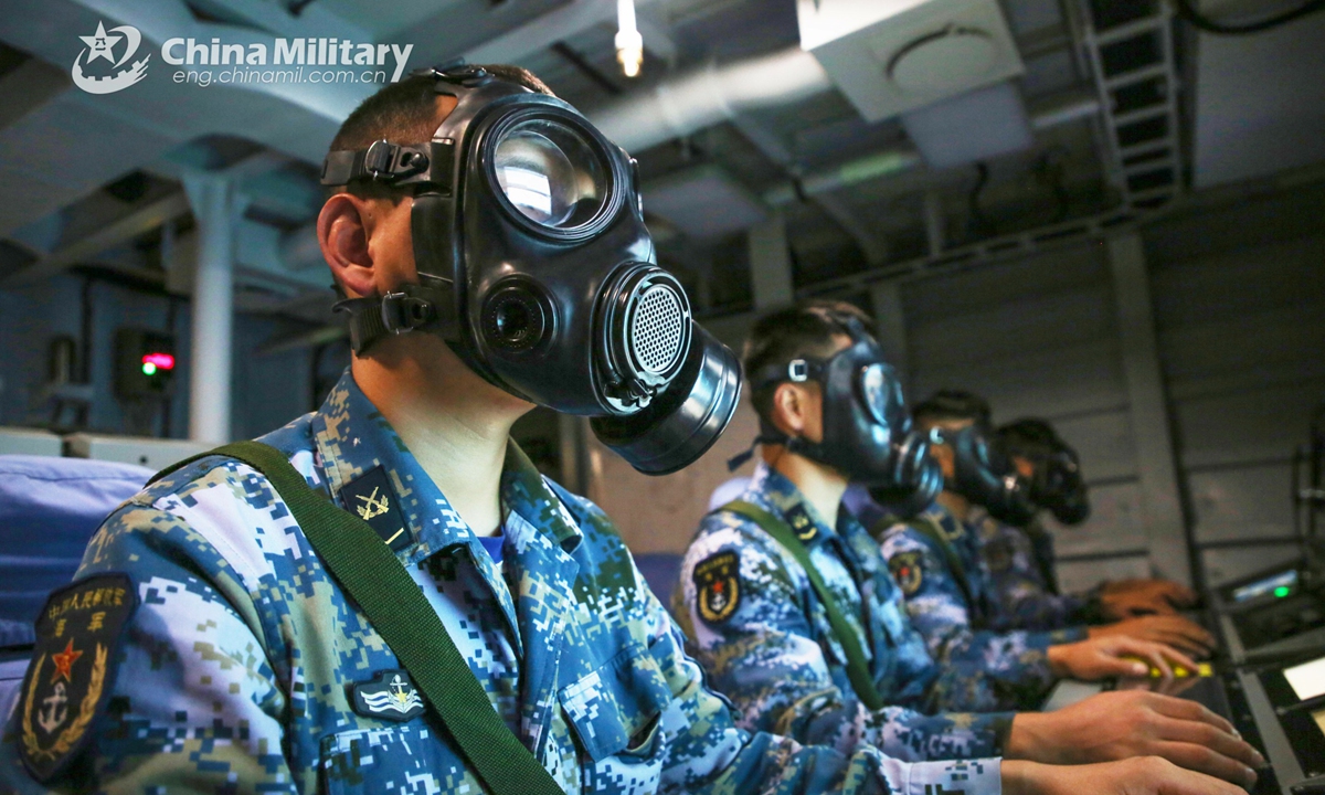Sailors wearing masks assigned to a frigate flotilla with the navy under the PLA Southern Theater Command adeptly perform precise operation and give combat orders in the commanding room aboard the guided-missile frigate Wuzhou (Hull 626) during a maritime training operation in early December, 2021.Photo:China Military