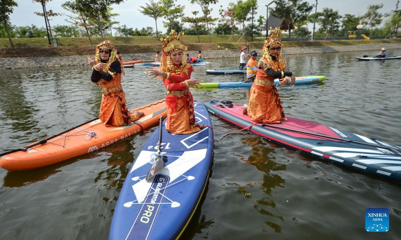 Women wearing Indonesian traditional clothes perform traditional dance on their paddle during celebration of National Mother's Day at Greenbelt of Pantai Indah Kapuk in Jakarta, Indonesia, on Dec 18, 2021. Indonesia commemorates the National Mother's Day on Dec 22 every year.Photo:Xinhua