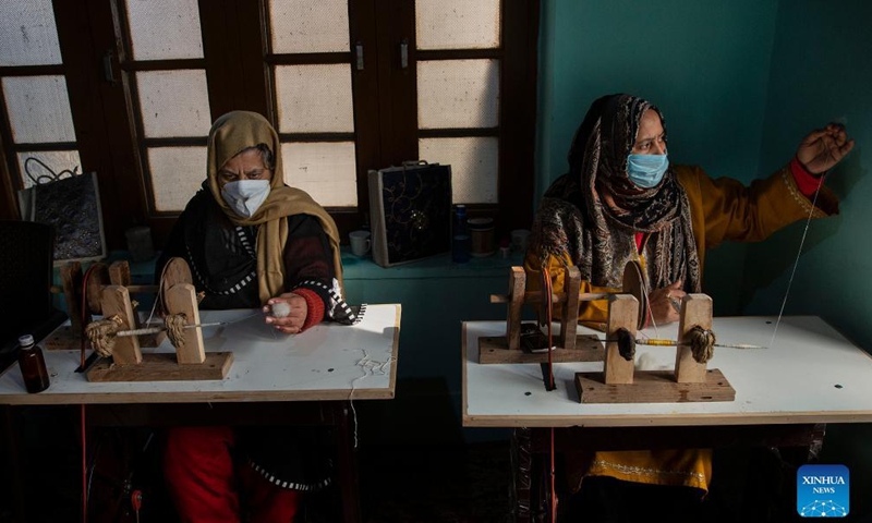 Artisans make woolen threads at a workshop in Srinagar city, the summer capital of Indian-controlled Kashmir, Dec. 18, 2021.Photo:Xinhua