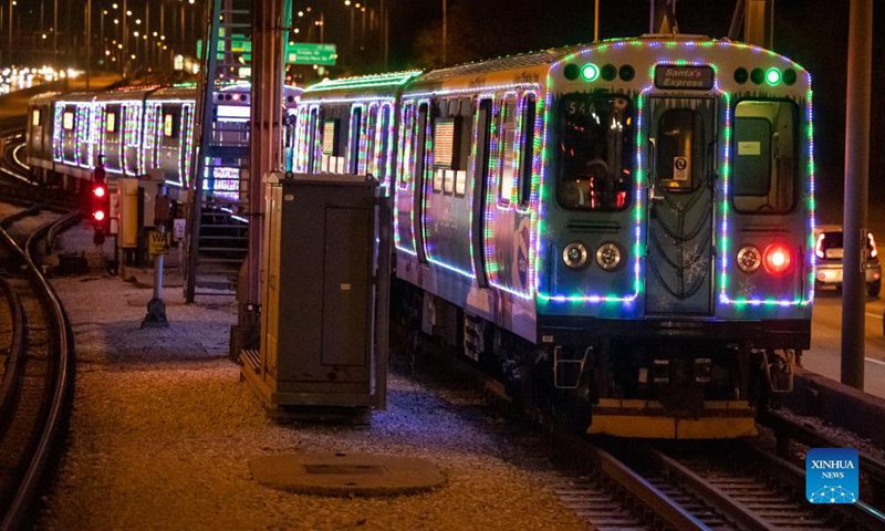 The Holiday Train leaves the Addison station on the Blue Line in Chicago, the United States, Dec. 18, 2021. The year of 2021 marks the 30th anniversary for the Holiday Train service by Chicago Transit Authority. (Photo by Joel Lerner/Xinhua)