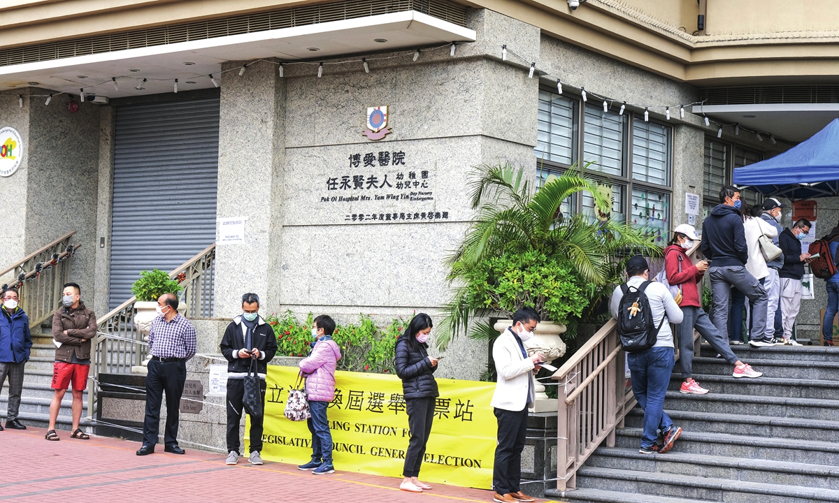 Voters line up outside a polling station at Whampoa in Hong Kong to cast their votes for the Legislative Council, the first election since the city implemented the electoral reform that ensures only patriots govern Hong Kong. Photo: Xinhua 
