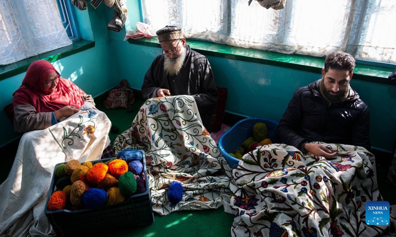 Artisans make embroidery on curtains at a workshop in Srinagar city, the summer capital of Indian-controlled Kashmir, Dec. 18, 2021.Photo:Xinhua