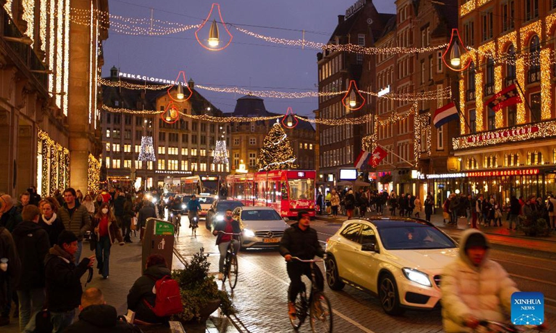 People walk on a street with Christmas decorations in Amsterdam, the Netherlands, on Dec. 18, 2021.Photo:Xinhua