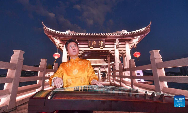 Musician Chen Junhui plays Chaozhou music with Guzheng, a traditional Chinese musical instrument, in Chaozhou, south China's Guangdong Province, Dec. 14, 2021. Chaozhou music refers to all types of folk music popular in the Chaoshan region of eastern Guangdong Province in south China. With a history dating back over 1,000 years, traditional instruments such as suona, yehu, erxian (two-string fiddles), gongs, and drums are commonly used in performances.(Xinhua)