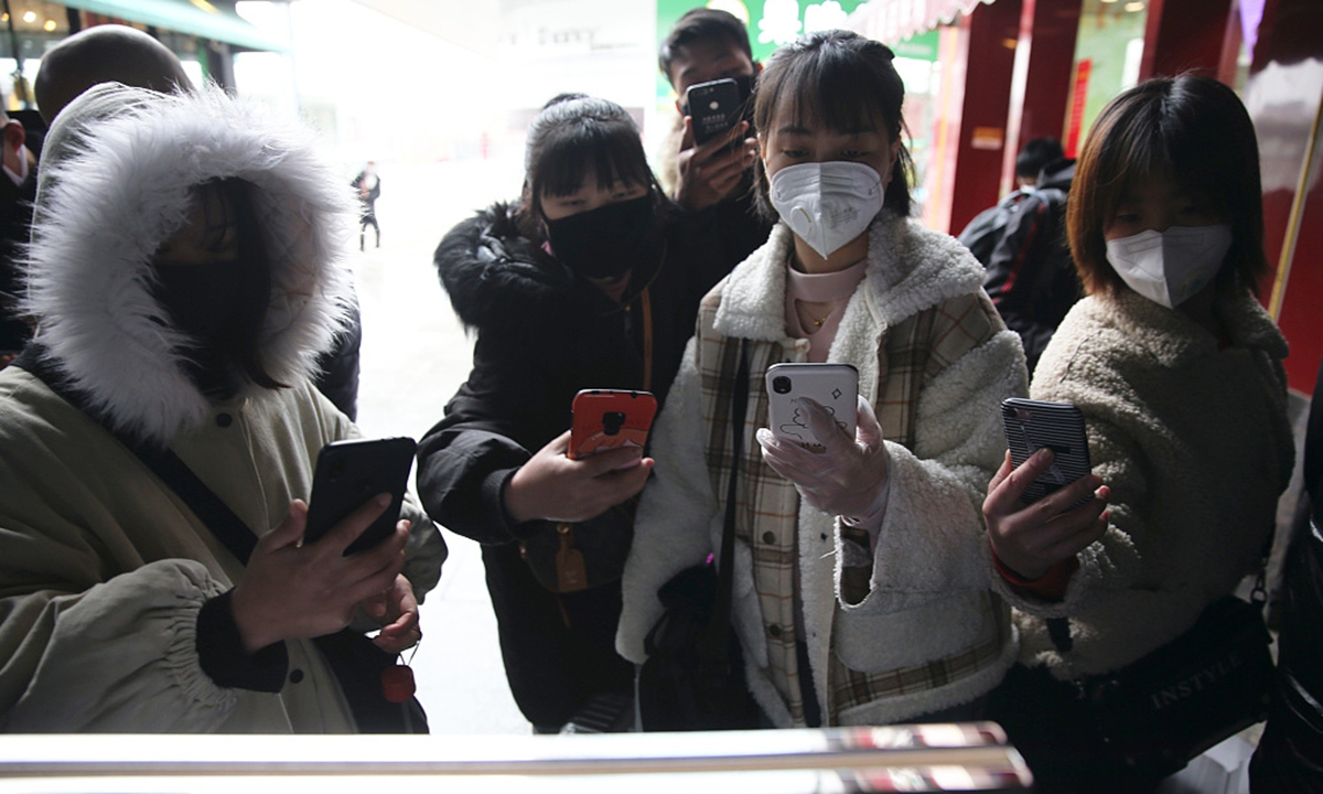 Residents scan the QR code at the entrance of a subway station, via local health code system to take subway trains in Xi’an, Shaanxi Province on March 2, 2020. Photo: VCG