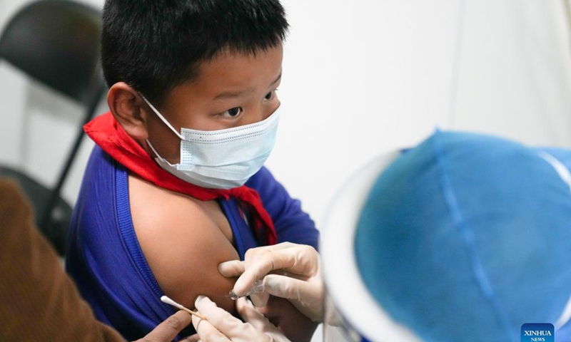 A medical worker administers a dose of COVID-19 vaccine to a child at a vaccination site in Panggezhuang Town of Daxing District in Beijing, capital of China, Nov. 4, 2021.Photo: Xinhua