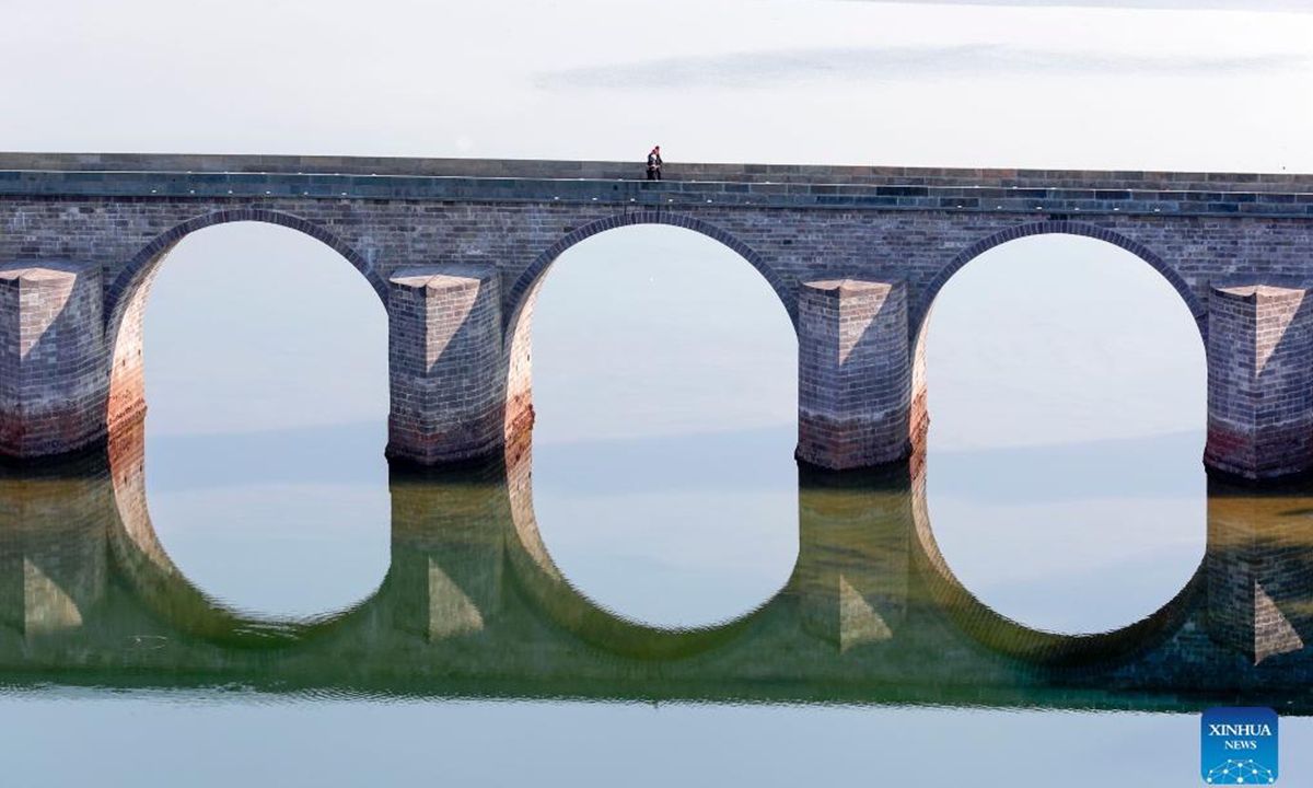 An ancient bridge destroyed by floods in east China's Anhui Province will reopen soon after repair, local authorities said. The repair work, which started on Nov. 13, 2020, has been completed and passed quality inspection on Tuesday. The Zhenhai Bridge, built during the Ming Dynasty (1368-1644), was a state-level cultural relics protection site in the city of Huangshan. Floodwaters destroyed the 131-meter-long bridge during a heavy rainstorm on July 7, 2020. (Photo by Shi Yalei/Xinhua)