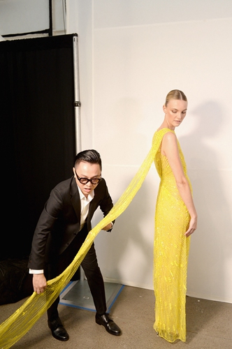 Designer Nguyen Cong Tri (left) prepares a model backstage for the Cong Tri fashion show during New York Fashion Week on February 11, 2019 in New York City. Photo: AFP