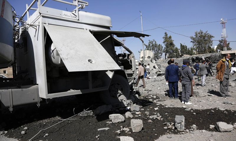 People inspect a building destroyed in airstrikes by the Saudi Arabia-led coalition at the Sanaa International Airport in Sanaa, Yemen, on Dec. 21, 2021.(Photo: Xinhua)