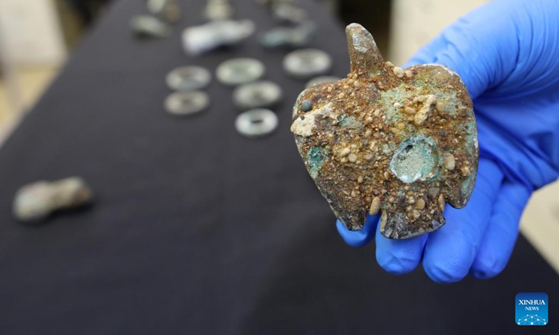 An artifact found from an ancient shipwreck in the Mediterranean Sea, is displayed at the Israel Antiquities Authority lab in Jerusalem on Dec. 22, 2021. Israeli marine archaeologists have found some rare treasure from two ancient shipwrecks in the Mediterranean Sea, the Israel Antiquities Authority (IAA) said on Wednesday.(Photo: Xinhua)