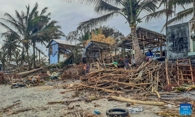 Photo shows a fishing community damaged by Typhoon Rai along a shoreline in Leyte Province, the Philippines, Dec. 22, 2021.The National Disaster Risk Reduction and Management Council (NDRRMC) reported that 156 people died from the typhoon, while the Philippine National Police reported at least 375 deaths. Many more are missing or injured.(Photo: Xinhua)