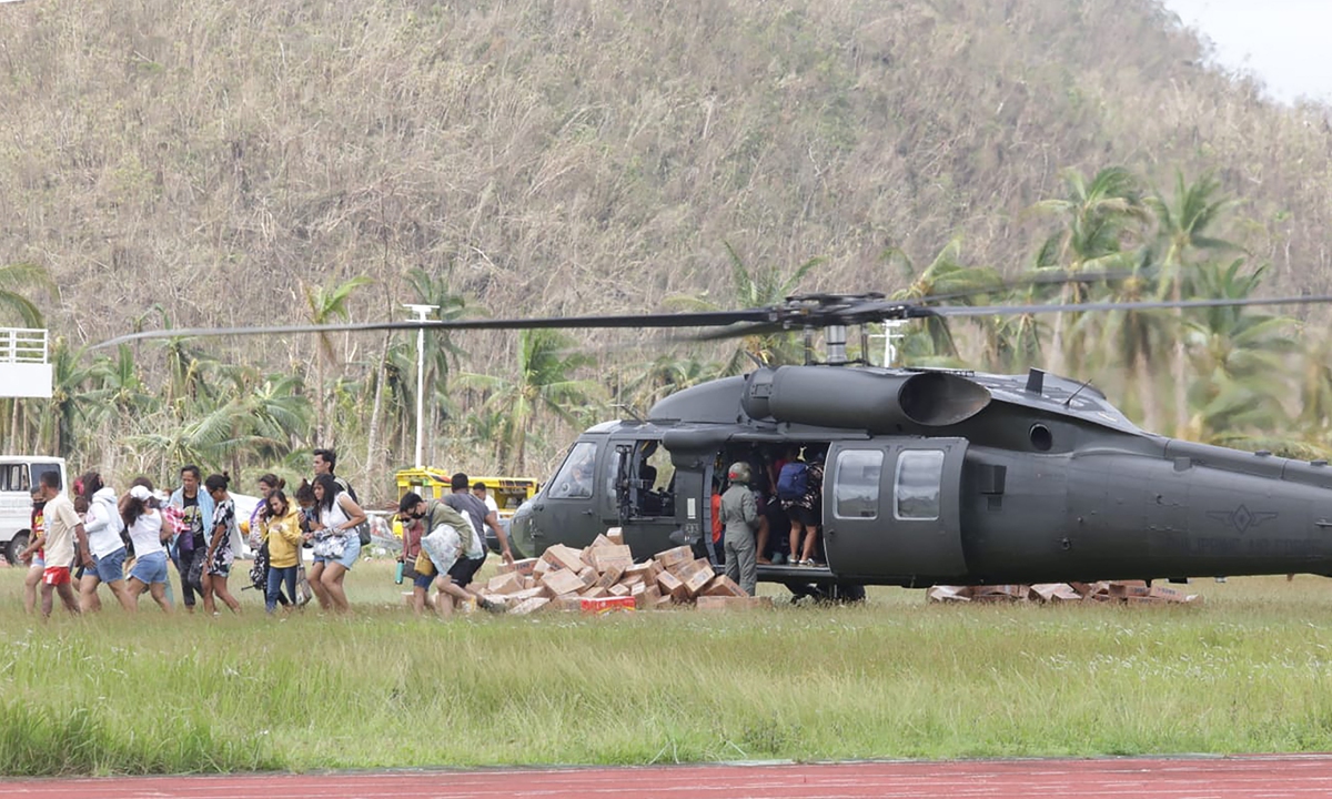 Residents leave the landing site at a sports complex in Dapa town, Siargao island, on December 21, 2021. Photo: AFP