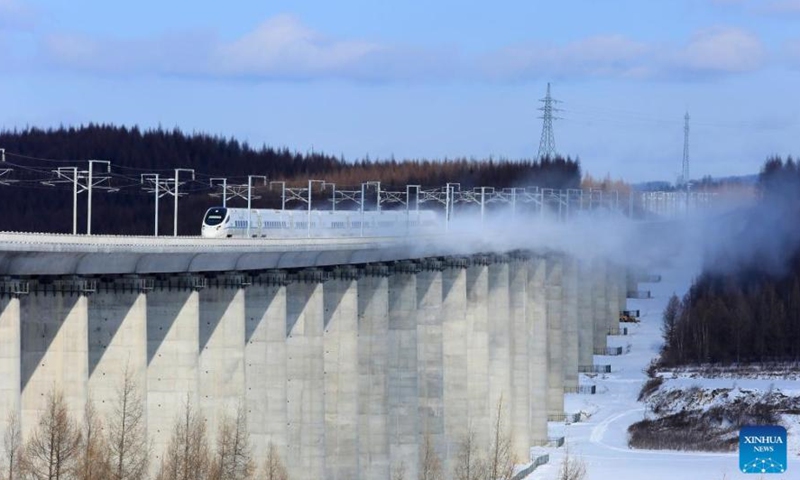 Aerial photo taken on Dec. 3, 2021 shows a high-speed train running in a trial operation of the new railway line reaching the foot of the Changbai Mountains in northeast China's Jilin Province. A new high-speed railway line reaching the foot of the Changbai Mountains in Jilin Province was put into operation on Dec. 24.(Photo by Liu Shenku/Xinhua)
