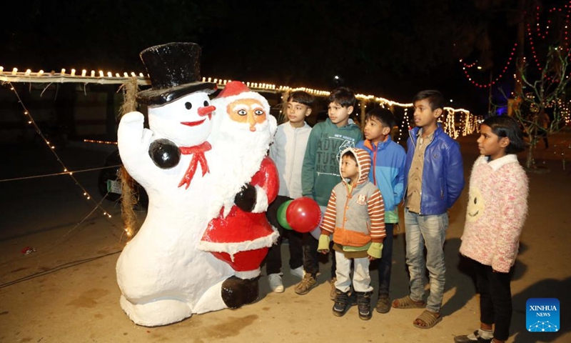 Children visit a decorated neighborhood on Christmas Eve in Islamabad, Pakistan, Dec. 24, 2021.(Xinhua/Ahmad Kamal)