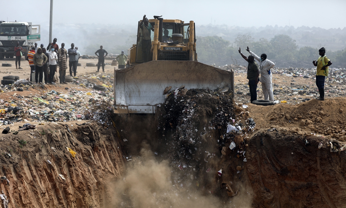 A truck offloads expired AstraZeneca coronavirus disease (COVID-19) vaccines into a pit at the Gosa dump site in Abuja, Nigeria on December 22, 2021. Photo: AFP